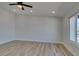 Bright living room featuring wood floors, neutral walls, and natural light from a large window at 706 Greenway Rd, Henderson, NV 89002