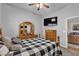 Cozy bedroom features a queen size bed, plush carpet and a matching wooden dresser at 7228 Fern Meadow St, Las Vegas, NV 89149