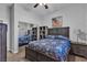 Bedroom with dark wood bed frame, neutral walls, and a mirrored closet door at 7228 Fern Meadow St, Las Vegas, NV 89149
