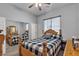 A bright bedroom features a patterned comforter, mirror closet doors, and a ceiling fan at 7228 Fern Meadow St, Las Vegas, NV 89149