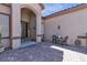 Charming front patio featuring brick pavers, seating area and a welcoming entrance to the home at 7228 Fern Meadow St, Las Vegas, NV 89149