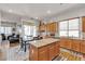 Updated kitchen featuring granite countertops, wood cabinetry, and an island with seating at 7228 Fern Meadow St, Las Vegas, NV 89149