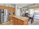The kitchen boasts a large central island with wood cabinets, stainless steel appliances, and hardwood floors at 7228 Fern Meadow St, Las Vegas, NV 89149