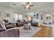 Spacious living room showcases leather furniture, hardwood floors, a ceiling fan, and lots of natural light at 7228 Fern Meadow St, Las Vegas, NV 89149