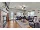 An inviting living room features leather furniture, wood floors, a fireplace and large windows at 7228 Fern Meadow St, Las Vegas, NV 89149