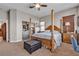 The main bedroom offers a four-poster bed, side tables, plush carpet, and a view of the backyard at 7228 Fern Meadow St, Las Vegas, NV 89149