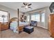 The main bedroom boasts an ornate four-poster bed, side tables, an ottoman, and an ensuite bath at 7228 Fern Meadow St, Las Vegas, NV 89149