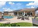 Entertain in this backyard featuring a pool, fire pit, covered patio and lush artificial grass at 7289 Sea Anchor Ct, Las Vegas, NV 89131