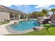 Resort-style backyard with pool, rock features, covered patio, and outdoor dining area at 7289 Sea Anchor Ct, Las Vegas, NV 89131