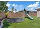 A fun backyard with a playground, slide, trampoline, and artificial grass at 7289 Sea Anchor Ct, Las Vegas, NV 89131