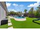 Spacious backyard featuring a pool, a waterslide, grassy areas, and a playground at 7289 Sea Anchor Ct, Las Vegas, NV 89131
