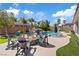 Lush backyard featuring a pool with a rock waterfall and built-in slide and a cozy firepit at 7289 Sea Anchor Ct, Las Vegas, NV 89131