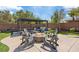 Relaxing backyard setting with a fire pit, lounge chairs, and shaded dining area at 7289 Sea Anchor Ct, Las Vegas, NV 89131