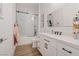 Bathroom features a shower with subway tile, and a modern vanity with black hardware at 7289 Sea Anchor Ct, Las Vegas, NV 89131