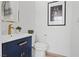Elegant powder room with blue vanity, modern gold faucet, and decorative accents at 7289 Sea Anchor Ct, Las Vegas, NV 89131