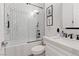Bathroom features a shower with subway tile, and a modern vanity with black hardware and framed art at 7289 Sea Anchor Ct, Las Vegas, NV 89131