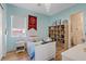 Bright bedroom with a white bedframe and wood floors, adjacent to a bathroom at 7289 Sea Anchor Ct, Las Vegas, NV 89131