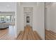 Bright hallway with hardwood floors leading to a living area with comfortable seating at 7289 Sea Anchor Ct, Las Vegas, NV 89131