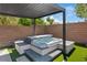 Relaxing hot tub with pergola offers a luxurious outdoor experience on artificial turf at 7289 Sea Anchor Ct, Las Vegas, NV 89131