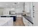 Modern kitchen with white cabinets, stainless steel appliances, navy blue island, and herringbone backsplash at 7289 Sea Anchor Ct, Las Vegas, NV 89131
