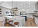 Bright, modern kitchen with large marble island, stainless appliances, and custom white cabinetry at 7289 Sea Anchor Ct, Las Vegas, NV 89131