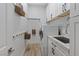 Well-organized laundry room with white cabinets, shelving, modern washer and dryer, and sink at 7289 Sea Anchor Ct, Las Vegas, NV 89131