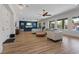 Bright and open living room featuring modern decor, hardwood floors, and large windows with a view to the pool at 7289 Sea Anchor Ct, Las Vegas, NV 89131