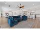 Spacious living room featuring a large sectional sofa that connects to a modern kitchen with bar stool seating at 7289 Sea Anchor Ct, Las Vegas, NV 89131