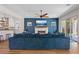Cozy living room showcasing a fireplace, blue accent wall, and a large sectional sofa at 7289 Sea Anchor Ct, Las Vegas, NV 89131