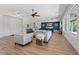 Open-concept living space with hardwood floors, stylish furnishings, and an open view of the kitchen at 7289 Sea Anchor Ct, Las Vegas, NV 89131
