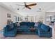 Comfortable living room featuring an oversized blue sectional and hardwood floors at 7289 Sea Anchor Ct, Las Vegas, NV 89131