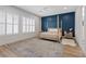 Main bedroom with canopy bed, shuttered windows, blue accent wall, and modern furniture at 7289 Sea Anchor Ct, Las Vegas, NV 89131