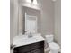 Neutral toned powder bath featuring a black vanity with white sink at 7300 Lavender Rose Ave, Las Vegas, NV 89117