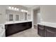Bathroom featuring dual sinks, large mirrors, and plenty of counter space at 7300 Lavender Rose Ave, Las Vegas, NV 89117