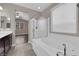 This primary bathroom includes a luxurious tub and walk-in shower at 7300 Lavender Rose Ave, Las Vegas, NV 89117