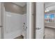 Bathroom with shower-tub combination and a white tiled surround at 7300 Lavender Rose Ave, Las Vegas, NV 89117
