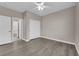 This bedroom features wood floors, a ceiling fan, and ample closet space at 7300 Lavender Rose Ave, Las Vegas, NV 89117
