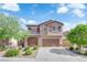 Charming two-story home featuring a finished two car garage, desert landscaping and a welcoming facade at 7300 Lavender Rose Ave, Las Vegas, NV 89117