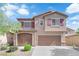 Charming two-story home featuring a finished two car garage, desert landscaping and a welcoming facade at 7300 Lavender Rose Ave, Las Vegas, NV 89117