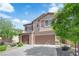 Charming two-story home featuring a finished two car garage, desert landscaping and a welcoming facade at 7300 Lavender Rose Ave, Las Vegas, NV 89117