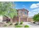 Charming two-story home featuring a finished two car garage, desert landscaping and a welcoming facade at 7300 Lavender Rose Ave, Las Vegas, NV 89117