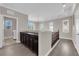 Bright hallway with railing, wood floors, natural light, and built-in cabinets at 7300 Lavender Rose Ave, Las Vegas, NV 89117