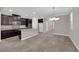Open kitchen and dining area with dark cabinets, granite countertops, and stainless steel appliances at 7300 Lavender Rose Ave, Las Vegas, NV 89117
