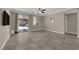 Spacious living area boasts a sliding door to the patio, a ceiling fan, and neutral-toned walls at 7300 Lavender Rose Ave, Las Vegas, NV 89117