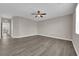 Spacious living room with wood floors and a modern ceiling fan at 7300 Lavender Rose Ave, Las Vegas, NV 89117