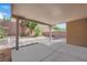 Spacious covered patio with palm trees, landscaping, and block wall fence at 7300 Lavender Rose Ave, Las Vegas, NV 89117