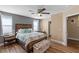 Comfortable bedroom boasts wood floors, ceiling fan, and a stylish furniture set at 779 Peregrine Falcon St, Henderson, NV 89015