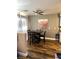 Well-lit dining area featuring modern ceiling fan and wood-look flooring at 779 Peregrine Falcon St, Henderson, NV 89015