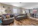 Comfortable living room with wood-look flooring and neutral decor at 779 Peregrine Falcon St, Henderson, NV 89015