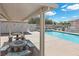Community pool featuring clear blue water, picnic tables, and nearby restrooms for residents' comfort and enjoyment at 779 Peregrine Falcon St, Henderson, NV 89015